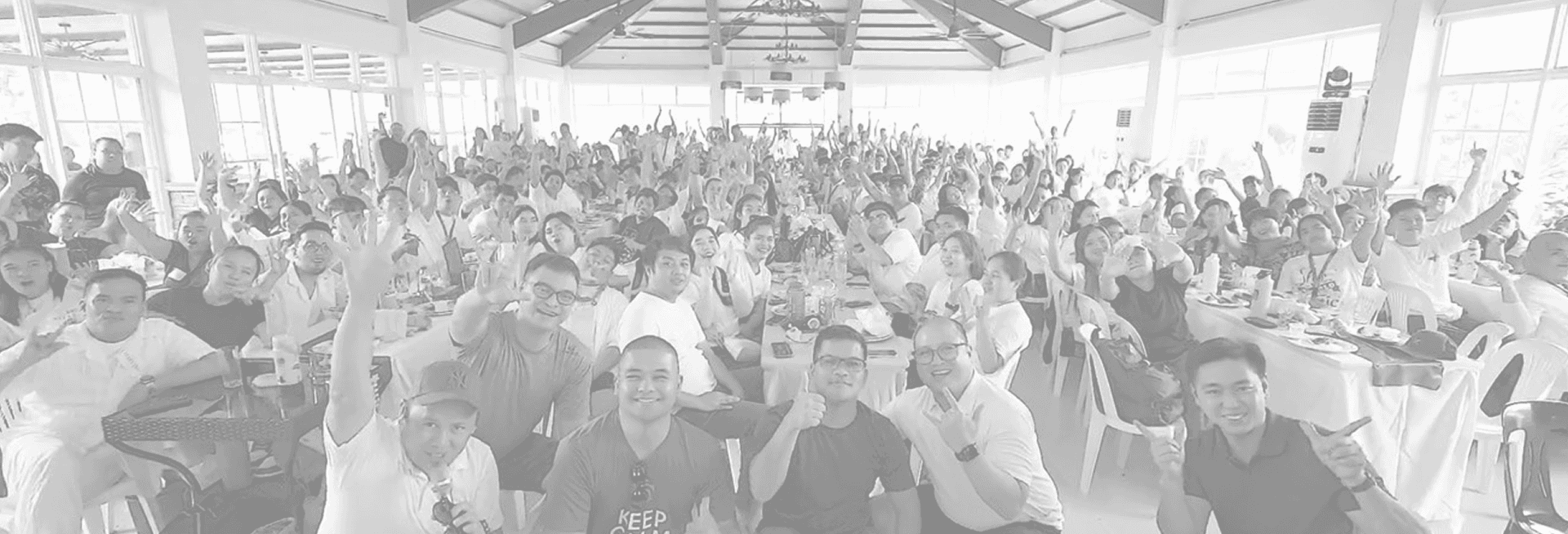 1Life team members gathered together in a large community hall.